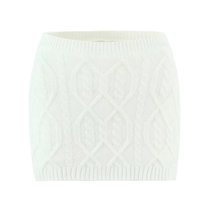 Detailed view of white cable-knit texture and diamond patterns on a knit mini skirt