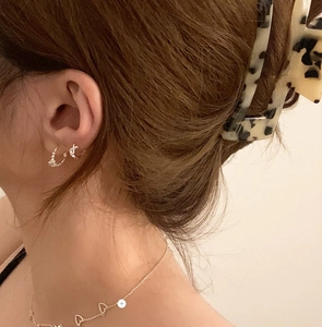 Close-up of minimalist S925 sterling silver hoop earrings and heart necklace on model