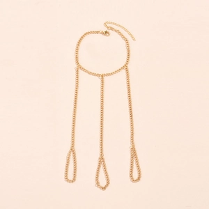 Detail of gold metal body chain jewelry with lobster clasp and adjustable extension chain