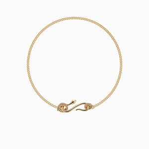 Close-up of gold snake pendant necklace with shimmering pavé diamond accents and curb chain