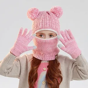 Pink children's winter knit balaclava hat and touchscreen gloves set with plush pom-poms