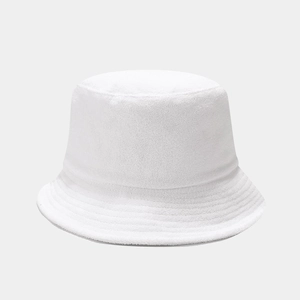 Detailed texture of white terry cloth bucket hat fabric with soft minimalist lighting