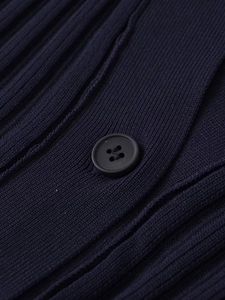 Detailed close-up of dark blue ribbed knit fabric with a black four-hole button closure