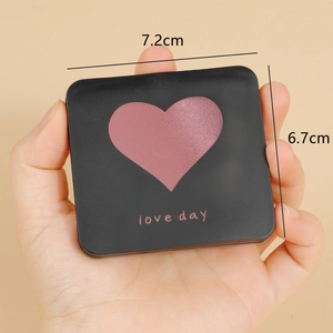 Mini portable folding makeup mirror in matte black with heart design for hand-held use