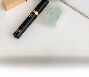 Close-up of portable storage pouch showing mascara and contact lens case inside