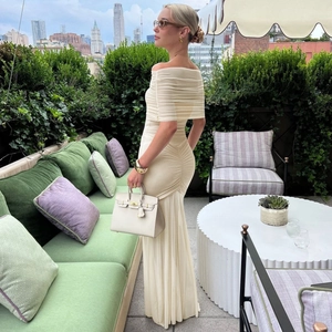 Detail of off-white mesh ruching on an off-shoulder dress with a mermaid hem