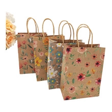 Detail of floral printed paper gift bags with twisted handles in four vintage patterns