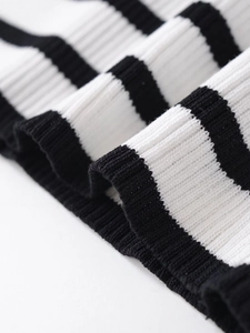 Macro detail of high-quality black and white striped knit fabric with ribbed texture