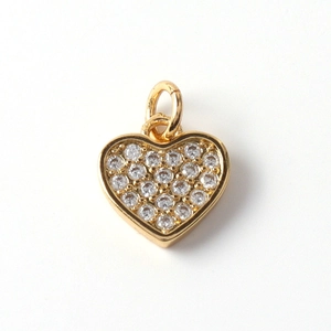Macro shot of gold-plated heart pendant with micro-paved cubic zirconia crystals