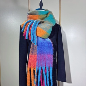 Close-up of rainbow plaid scarf with long tassels and thick faux cashmere texture