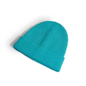 Detail showing the thick ribbed texture and teal knit fabric of the winter beanie hat