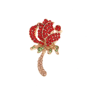 Sparkling red crystal rose brooch with green leaves and a golden metal base accessory