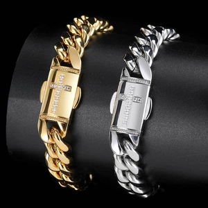 Gold and silver cuban chain bracelets with zircon cross clasp on black display stand