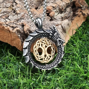 Viking Ouroboros dragon pendant necklace with Tree of Life on natural wood background