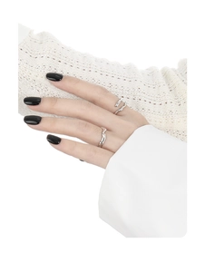 Close-up of irregular wave silver rings on hand with minimalist aesthetic design