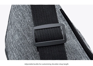 Detail of adjustable buckle and durable nylon strap on a gray lightweight crossbody bag