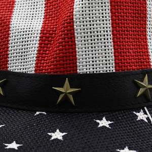 Macro detail of American flag straw hat with star-studded leather band and woven texture