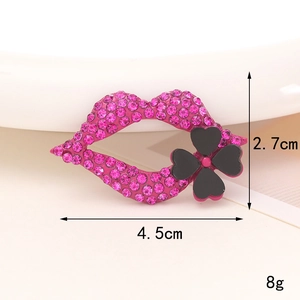 Detail shot of a rhinestone lip-shaped charm with measurements 4.5cm by 2.7cm