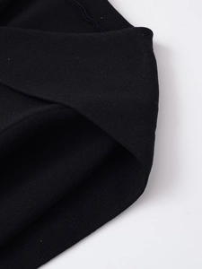 Close-up of premium black knitted fabric texture showing dense horizontal weave detail