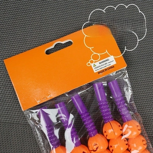 Halloween decorative pumpkin straws with orange heads and purple stems in clear retail packaging