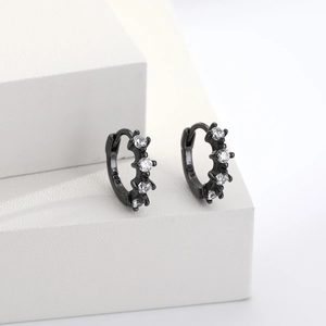 Macro detail of black S925 silver hoop earrings with clear round cubic zirconia inlay