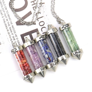 Close-up of five crystal gravel wishing bottle pendants with Love engraving details