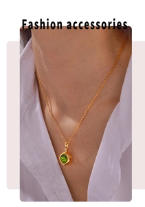 Close-up of a square emerald green zircon pendant on a delicate gold chain for women