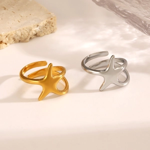 Minimalist stainless steel starfish open rings in gold and silver on stone background