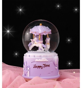 Close-up of a purple unicorn carousel music box with a castle base and dreamlike stars