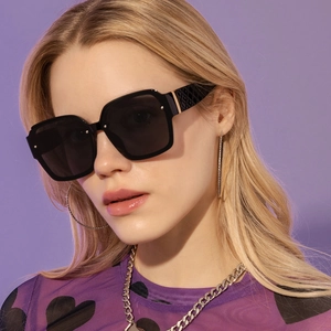 Detail view of square sunglasses featuring textured temples and golden metal accents