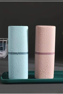 Close-up of portable blue and pink toothbrush cases with waterproof matte finish