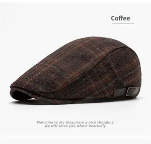 Detail of coffee plaid wool beret showing textured fabric and adjustable metal side buckle