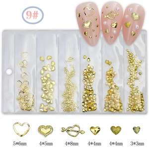 Detailed view of golden heart and Cupid's arrow nail charms in size 5x6mm and 4x8mm