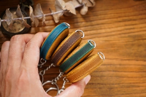 Macro detail of crazy horse leather tape measure covers with colorful edge painting