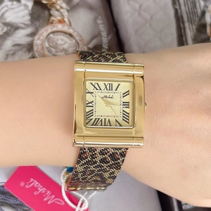 Rectangular gold watch with leopard print strap and Roman numerals worn on wrist