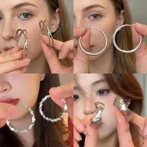 Set of four minimalist silver oval earrings featuring twisted and wavy metal textures