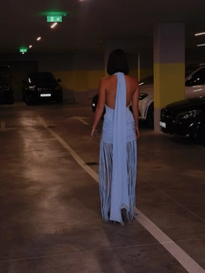 Detail of light blue halter backless dress featuring long flowing tassels in a modern style