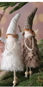 Close-up of plush angel doll with knitted hat and wooden bead legs on Christmas tree