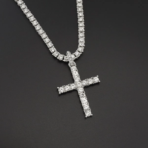 Macro detail of silver cross pendant and tennis chain set with sparkling cubic zirconia
