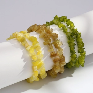 Close-up of irregular yellow brown and green cat-eye gravel stone beaded bracelets