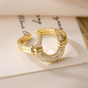 Macro shot of gold plated U-shaped open ring featuring double layer pavé set zircons