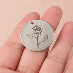 Minimalist 30mm rose flower engraved pendant necklace on a soft pink fabric background