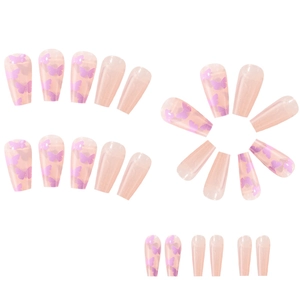 Detail of long French style press-on nails with purple butterfly designs on white background