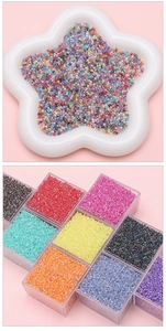 Macro view of multi-colored glass seed beads in star and square shaped containers