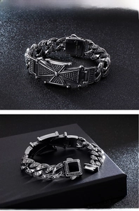 Macro detail of a 316L stainless steel bracelet showing Maltese cross and engraved links