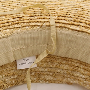 Detail of the straw sun hat interior showing the sweatband and adjustable size drawstring