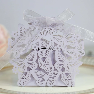 Close-up of laser-cut butterfly candy box in lavender with silver ribbon bow