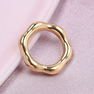 Detailed macro view of gold wavy flower shaped 304 stainless steel pendant with glossy finish
