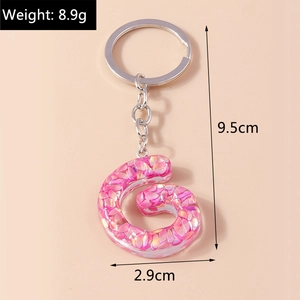 Pink sequin resin letter G keychain with measurements showing 9.5cm length and 8.9g weight