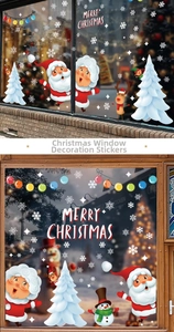 Close-up of Santa and reindeer window decals on glass with warm indoor Christmas lights